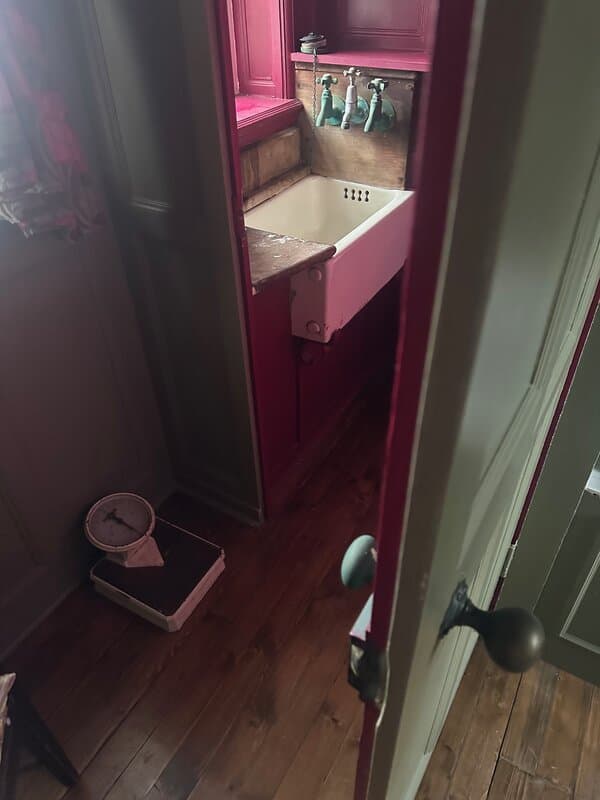 Original Maid's Cupboard in paneled bathroom