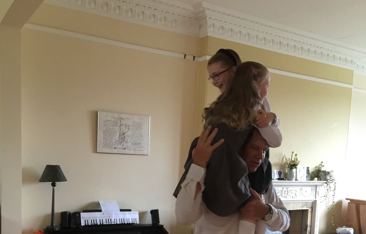 Amity and Cora on the shoulders of John