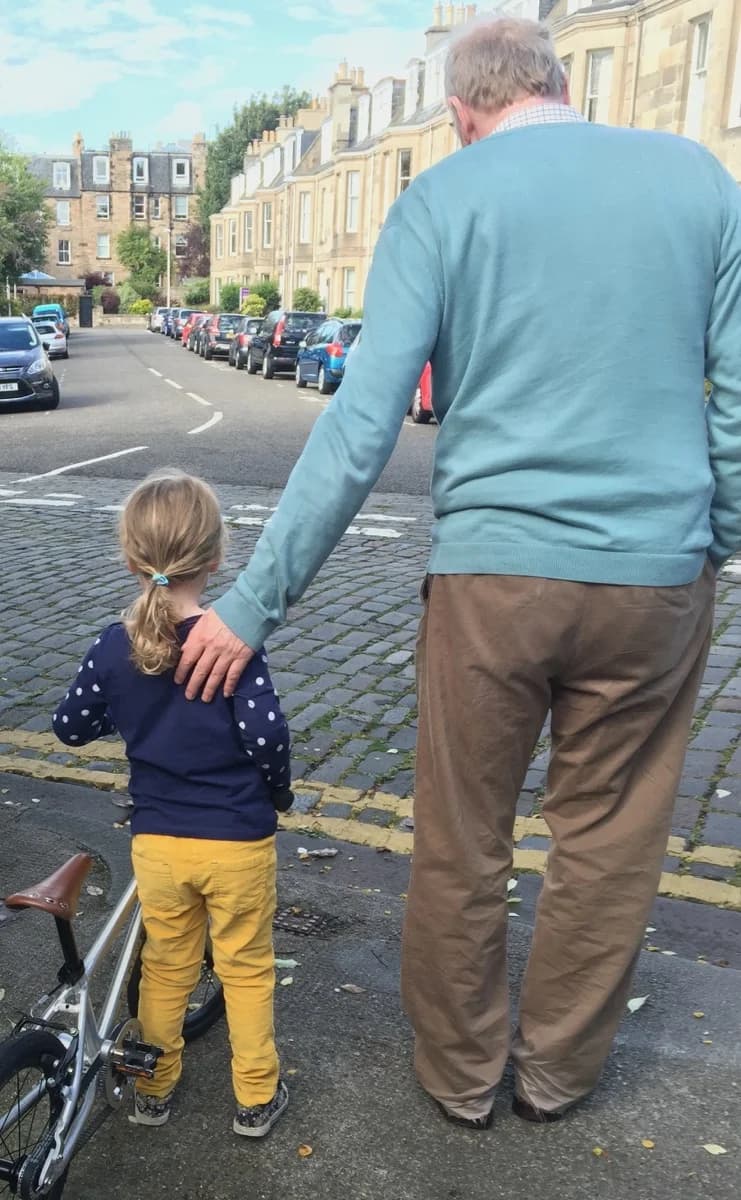 Cora learning to ride her bike in the safe cul-de-sac opposite the house
